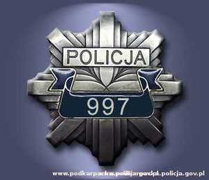 Logo Polskiej Policji- Gwiazda a w tle napis Policja oraz numer 997